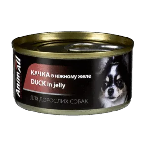 Консервна банка з їжею для собак з написом 'Качка в ніжному желе' і зображенням собаки.