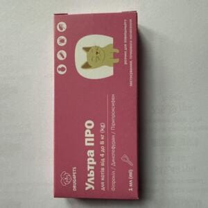 Упаковка препарату для котів на рожевому фоні з малюнком кота.