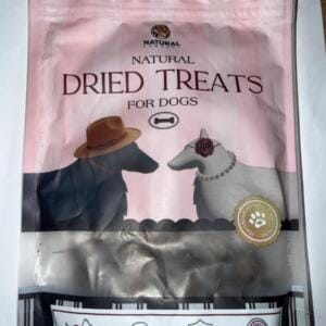 Пакет з натуральними сушеними ласощами для собак з зображеннями собак на фоні.