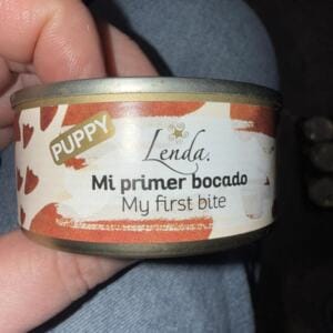 Консервна банка для собак з написом 'Mi primer bocado' та 'My first bite'